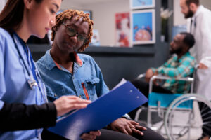 African american woman receiving instructions from physical therapist
