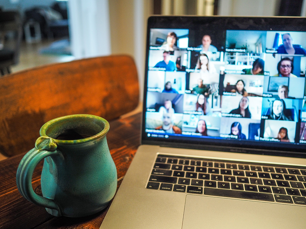 Laptop showing gallery view of profile photos on a Zoom call