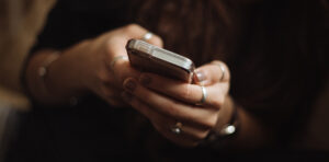Hands holding cell phone