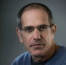 A man with short graying brown hair with glasses. Dr. Friedman