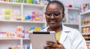 A pharmacist looks at a clipboard.